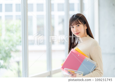 Female university student standing in the hallway Photography cooperation: Ariake College of Education and Arts Female university student standing in the hallway Photography cooperation: Ariake College of Education and Arts 109231745