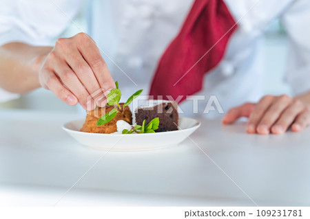 Pastry chef serving dessert Pastry chef serving dessert 109231781