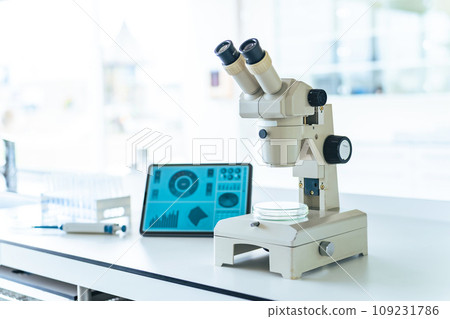 Microscope and tablet screen in the laboratory 109231786