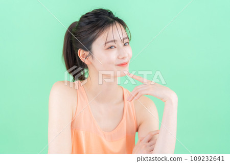 綠色背景下做護膚的年輕女性 綠色背景下做護膚的年輕女性 109232641