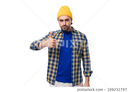 a young brutal brunette man with a beard and mustache in a shirt and cap shows class 109232797