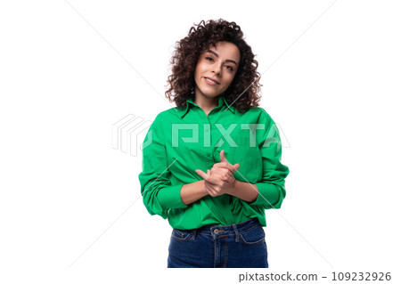 portrait of a 30 year old stylish caucasian brunette woman with a curled hair dressed in a green 109232926