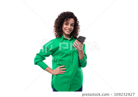 young brunette leader woman dressed in a green blouse holding a phone young brunette leader woman dressed in a green blouse holding a phone 109232927