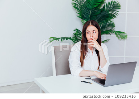 Business woman working online at computer in office Business woman working online at computer in office 109233416