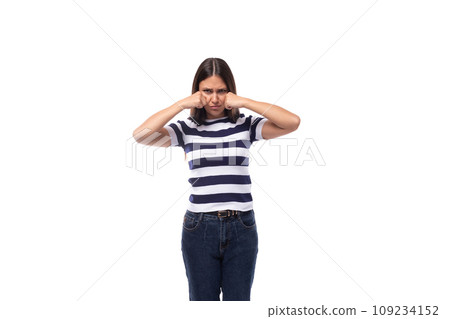 offended young brunette caucasian woman with light makeup dressed in a striped t-shirt and jeans offended young brunette caucasian woman with light makeup dressed in a striped t-shirt and jeans 109234152