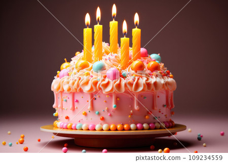 Pink birthday cake with a candles on the festive table 109234559