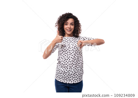 young dark-haired caucasian woman dressed in a blouse demonstrates like and dislike with her hands 109234809