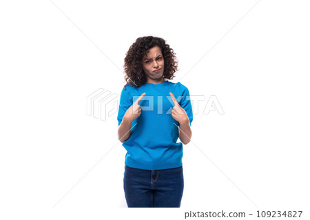 suspicious slim young caucasian woman with curls dressed in a blue t-shirt and jeans suspicious slim young caucasian woman with curls dressed in a blue t-shirt and jeans 109234827