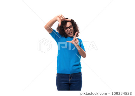 portrait of a young woman with curly hair dressed in a blue t-shirt working in the field of 109234828