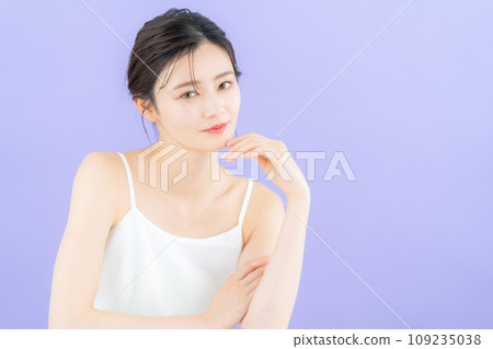 Young woman doing skin care with purple back 109235038