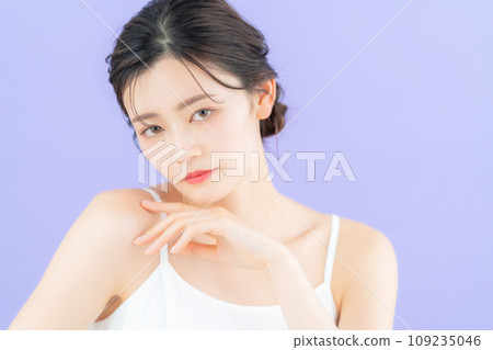 Young woman doing skin care with purple back Young woman doing skin care with purple back 109235046