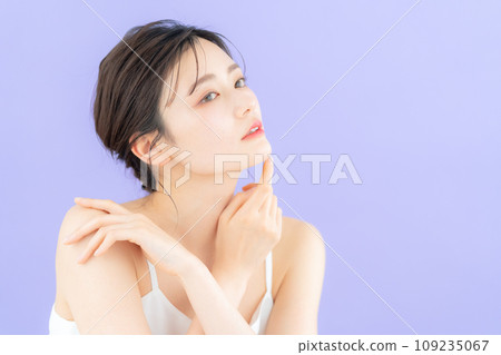 Young woman doing skin care with purple back 109235067