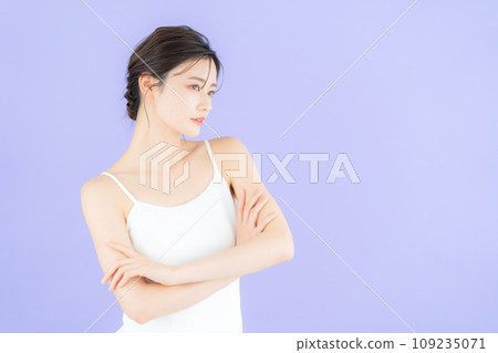 Young woman doing skin care with purple back Young woman doing skin care with purple back 109235071