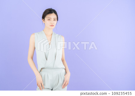 Young female fashion model posing with purple back Young female fashion model posing with purple back 109235455