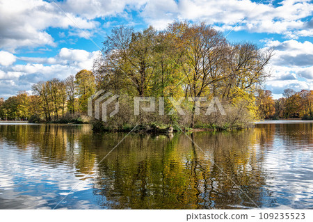Golden autumn view in famous Munich relax place - Englischer Garten. Munich, Bavaria, Germany Golden autumn view in famous Munich relax place - Englischer Garten. Munich, Bavaria, Germany 109235523