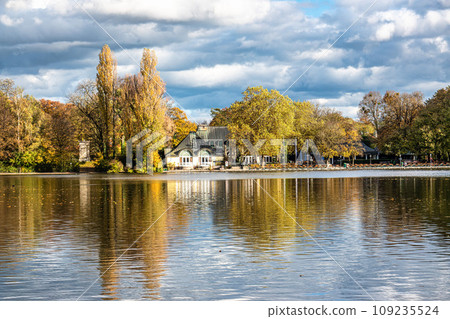 Golden autumn view in famous Munich relax place - Englischer Garten. Munich, Bavaria, Germany Golden autumn view in famous Munich relax place - Englischer Garten. Munich, Bavaria, Germany 109235524