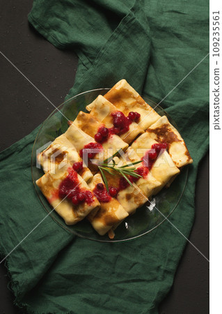 Pancakes stuffed with cheese with cranberry sauce 109235561