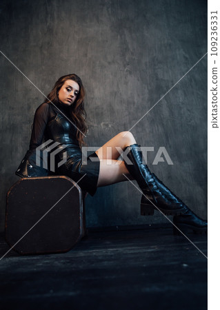 Portrait of a beautiful fashionable daring woman in dark clothes 109236331