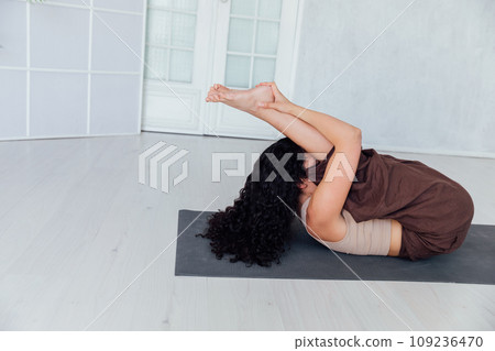 Woman doing yoga exercises asana gymnastics fitness Woman doing yoga exercises asana gymnastics fitness 109236470
