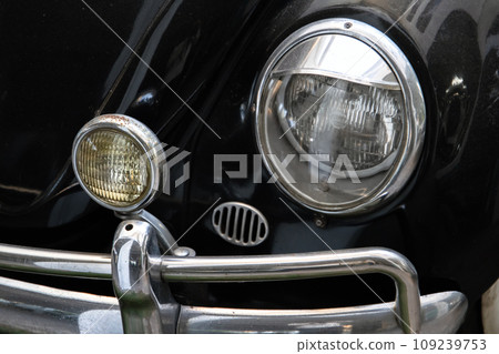 Round headlights of a vintage black car. Close-up Round headlights of a vintage black car. Close-up 109239753