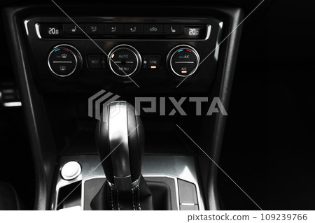 Gear lever and black climate control panel of a modern car. Close up 109239766