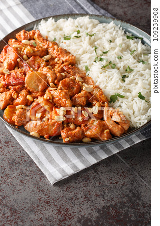 Flying Jacob is a Swedish casserole composed of chicken, cream, chilli sauce, bananas, roasted peanuts and bacon served with rice closeup on the plate. Vertical Flying Jacob is a Swedish casserole composed of chicken, cream, chilli sauce, bananas, roasted peanuts and bacon served with rice closeup on the plate. Vertical 109239908