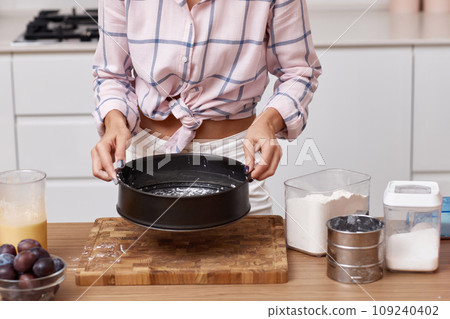 female hands preparing pie in modern kitchen female hands preparing pie in modern kitchen 109240402
