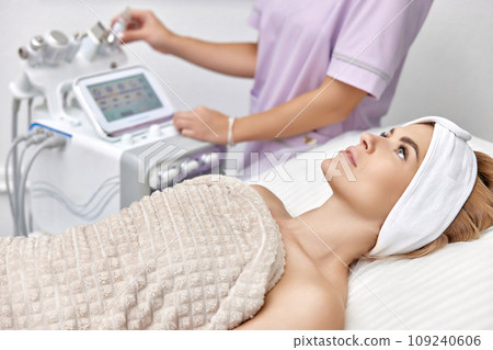 beautiful woman lying on bed during skincare procedure in beauty clinic. beautiful woman lying on bed during skincare procedure in beauty clinic. 109240606