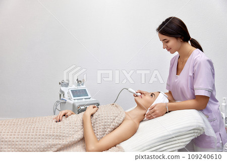 cosmetologist doing anti aging procedure in beauty salon. professional skin care 109240610
