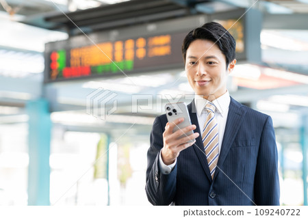 A businessman looking at his smartphone at the station. Photo provided by Keio Electric Railway Co., Ltd. A businessman looking at his smartphone at the station. Photo provided by Keio Electric Railway Co., Ltd. 109240722