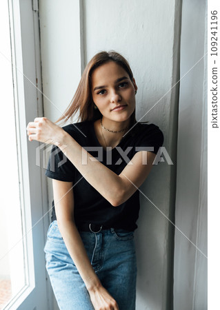 Portrait of beautiful young brunette woman in home clothes 109241196