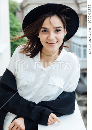 slender brunette woman walking in autumn city 109241221