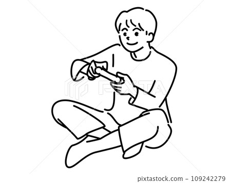 A boy sitting cross-legged and playing a game A boy sitting cross-legged and playing a game 109242279