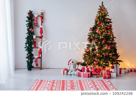 Christmas tree with gifts and toys in the interior for the new year Christmas tree with gifts and toys in the interior for the new year 109242286