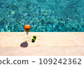 Glass of pink wine and yellow sunglasses at the pool. 109242362
