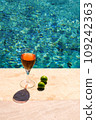 Glass of pink wine and yellow sunglasses at the pool. 109242363