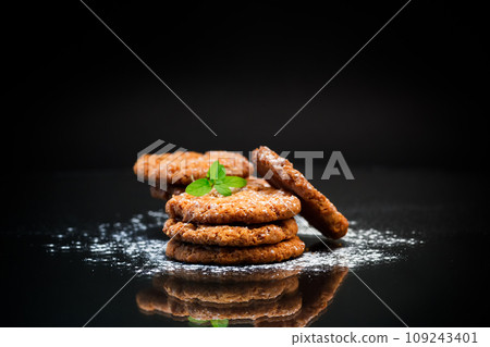cooked sweet oatmeal cookies on black background cooked sweet oatmeal cookies on black background 109243401