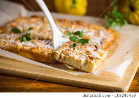 prepared curd semolina pie with quince inside and covered with powdered sugar . prepared curd semolina pie with quince inside and covered with powdered sugar . 109243459