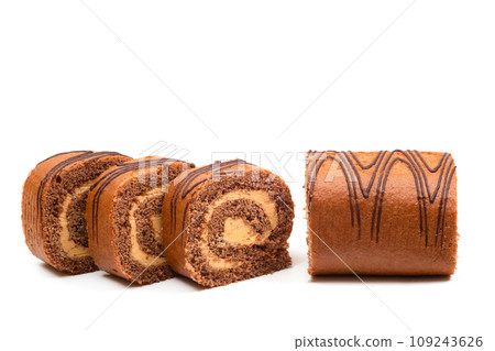 Sliced sponge roll with chocolate filling on a white background Sliced sponge roll with chocolate filling on a white background 109243626