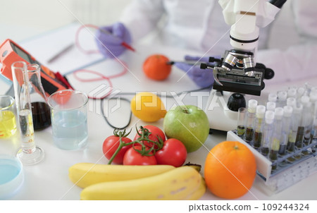 Scientist chemist studying amount of toxic substances in vegetables and fruits in chemical laboratory 109244324