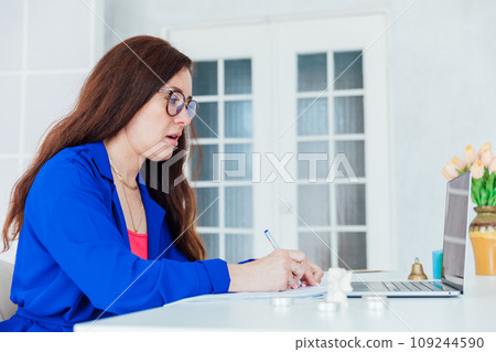 Woman with laptop chatting online at work in office with boss Woman with laptop chatting online at work in office with boss 109244590