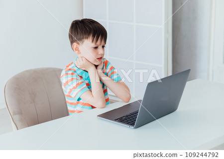 Boy doing online learning with laptop 109244792