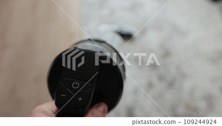 Man cleans the floor with a vacuum cleaner with a battery. House cleaning concept. Man cleans the floor with a vacuum cleaner with a battery. House cleaning concept. 109244924