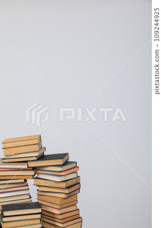 Many stacks of educational books to study in the university library on a background Many stacks of educational books to study in the university library on a background 109244925