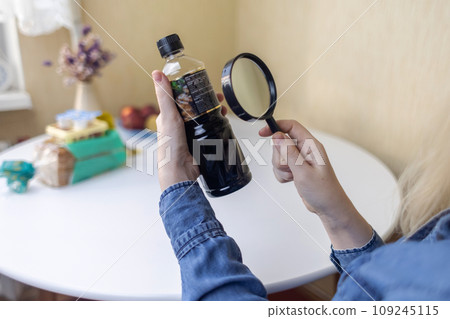 Woman reads instructions for food products at home. Checking labels on goods. Study of product compositions. Search Internet for descriptions of product gradients. Useful or harmful. Nutritionology 109245115