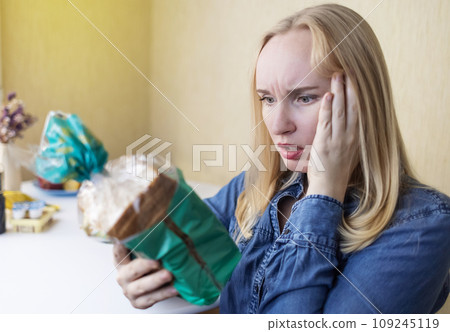 Woman reads instructions for food products at home. Checking labels on goods. Study of product compositions. Search Internet for descriptions of product gradients. Useful or harmful. Nutritionology Woman reads instructions for food products at home. Checking labels on goods. Study of product compositions. Search Internet for descriptions of product gradients. Useful or harmful. Nutritionology 109245119