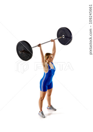 Top view. Full-length of young athlete, girl training, lifting heavy weights, barbell against white background 109245661
