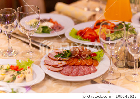 Served festive table with snacks, glasses, glasses, cutlery and napkins for a banquet 109246623