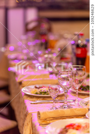 Served festive table with snacks, glasses, glasses, cutlery and napkins for a banquet 109246629