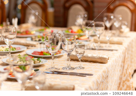Served festive table with snacks, glasses, glasses, cutlery and napkins for a banquet 109246648